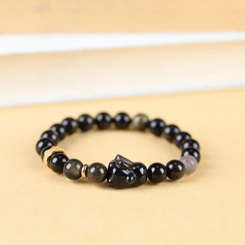 Handmade obsidian bracelet with lying rabbit charm, grey agate accents, and Yaoshi metallic elements in traditional national style