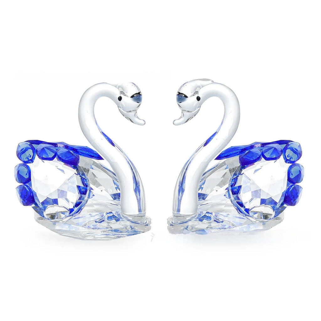 White crystal swan desktop ornament in red, blue, pink, or purple on a wooden surface.