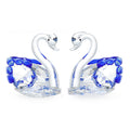 White crystal swan desktop ornament in red, blue, pink, or purple on a wooden surface.