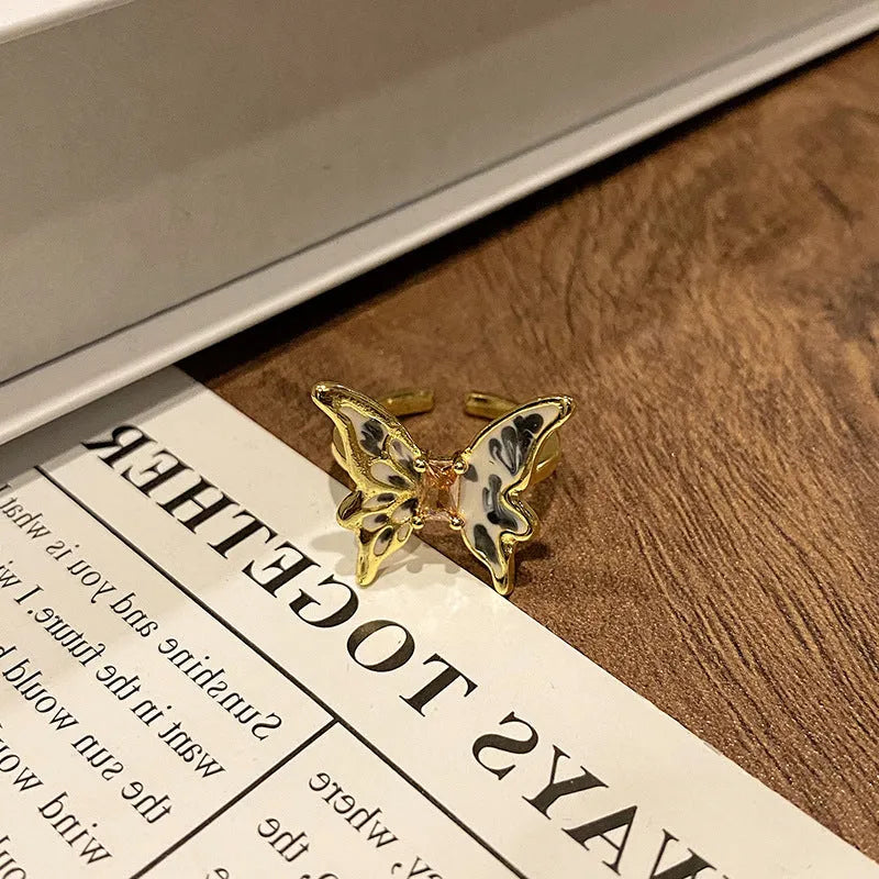 Copper butterfly women's ring with dripping oil texture and an open loop design.
