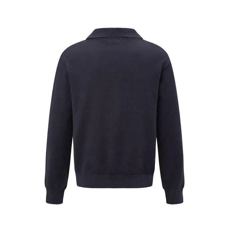 Man wearing a loose black pullover sweater for casual leisure wear.
