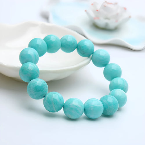 Natural blue-green amazonite bead bracelet with elastic band on a wrist.