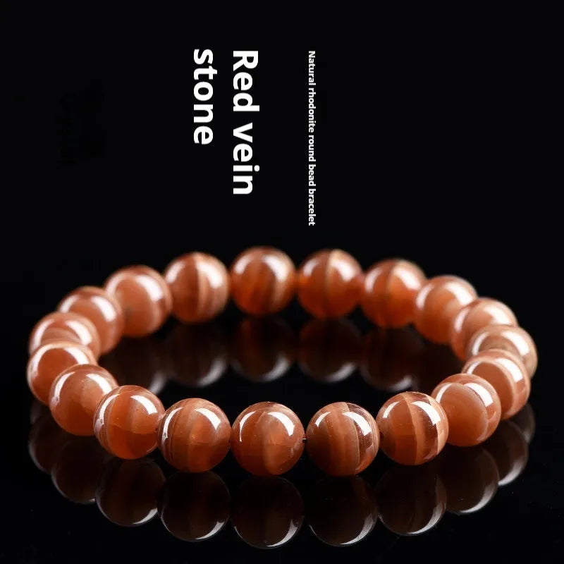 Natural Old Mine Rhodochrosite round bead bracelet with Ruyi charm, shown in 6mm and 8mm size options.