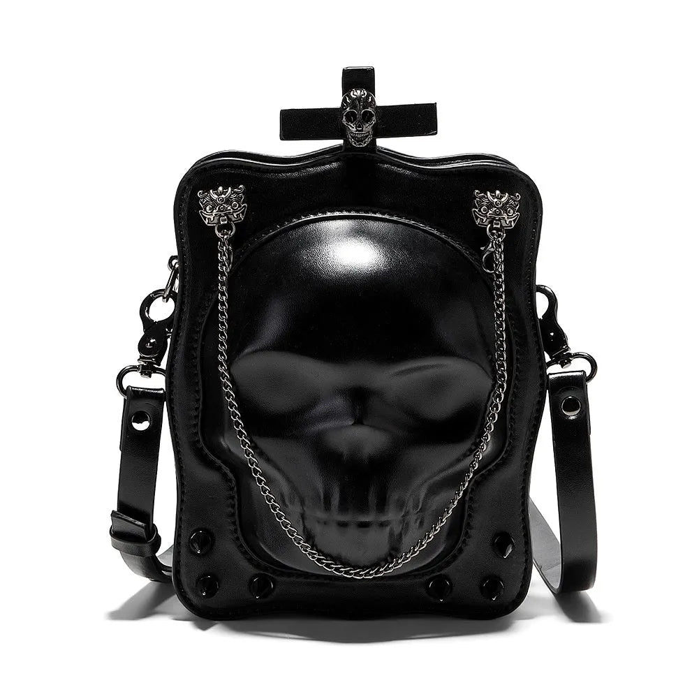 Black vertical square mini crossbody bag with embossed skull design, metal rivets, and chain strap.
