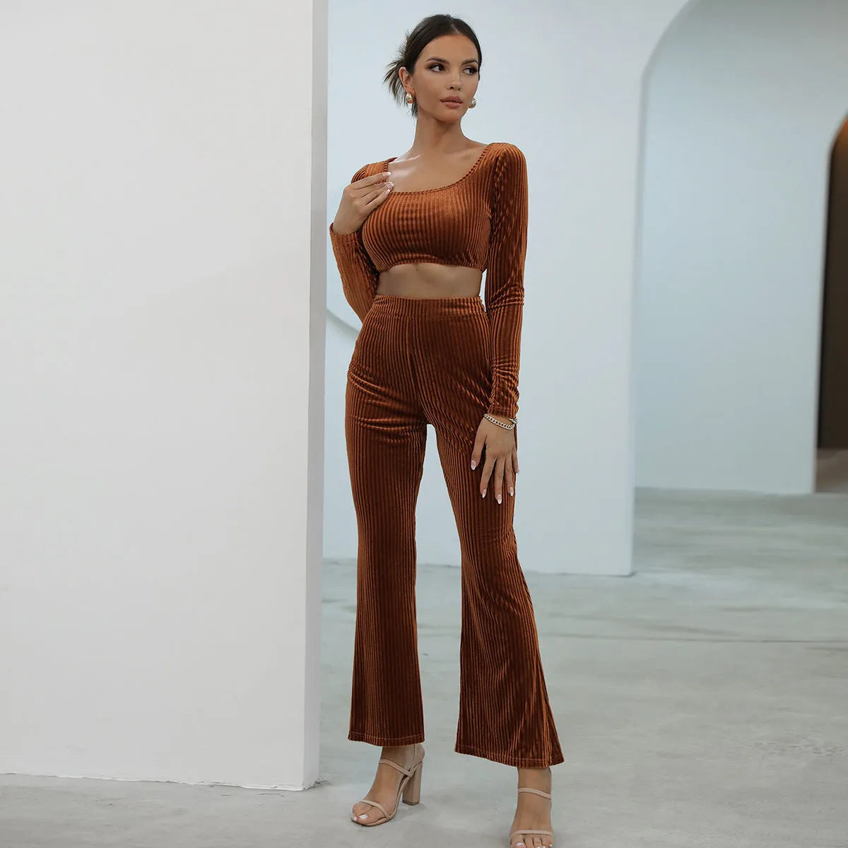 Caramel coloured long sleeve sweater and matching trousers set on a hanger.