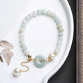 National style jade and pearl bracelet for women with a geometric peace buckle charm.