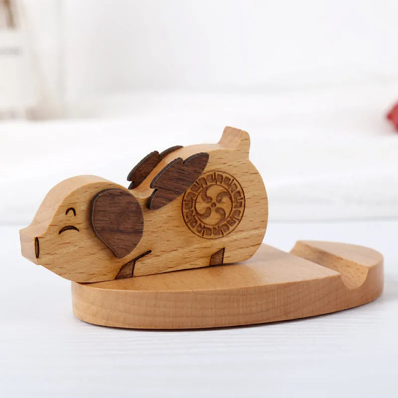 A decorative resin mobile phone stand holding a smartphone, shown in an animal design variant.