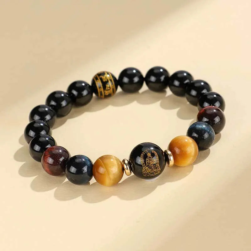 Handmade black agate beaded bracelet with gold, blue, and red tiger eye stones featuring Buddhist deity and zodiac animal motifs.
