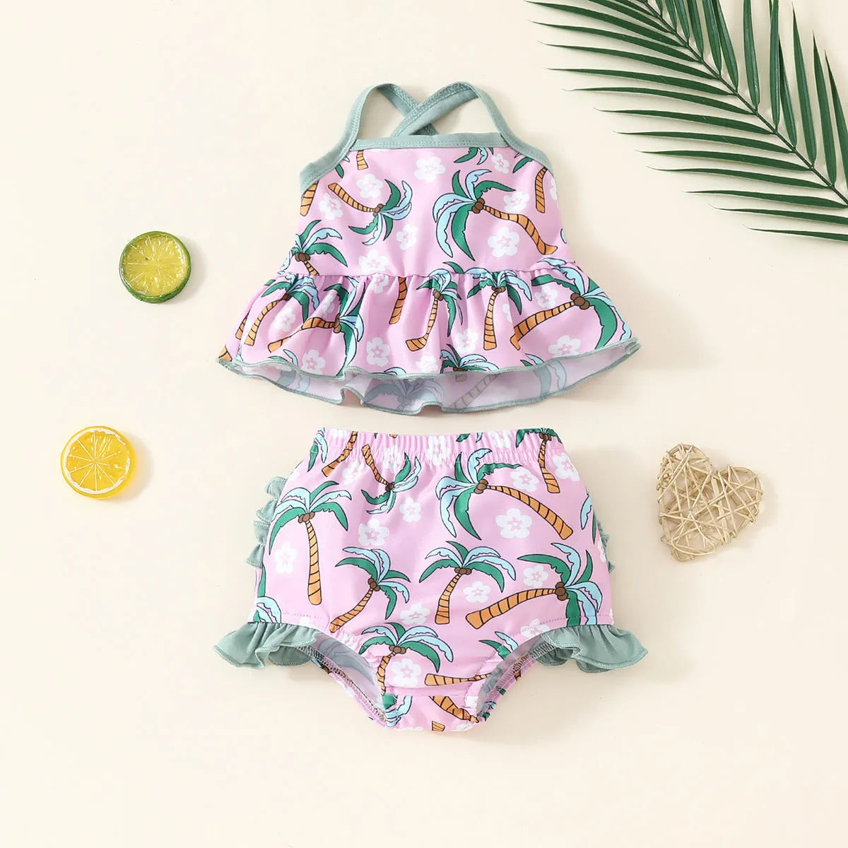 Toddler girl's white two-piece swimsuit set with shirt top and matching shorts