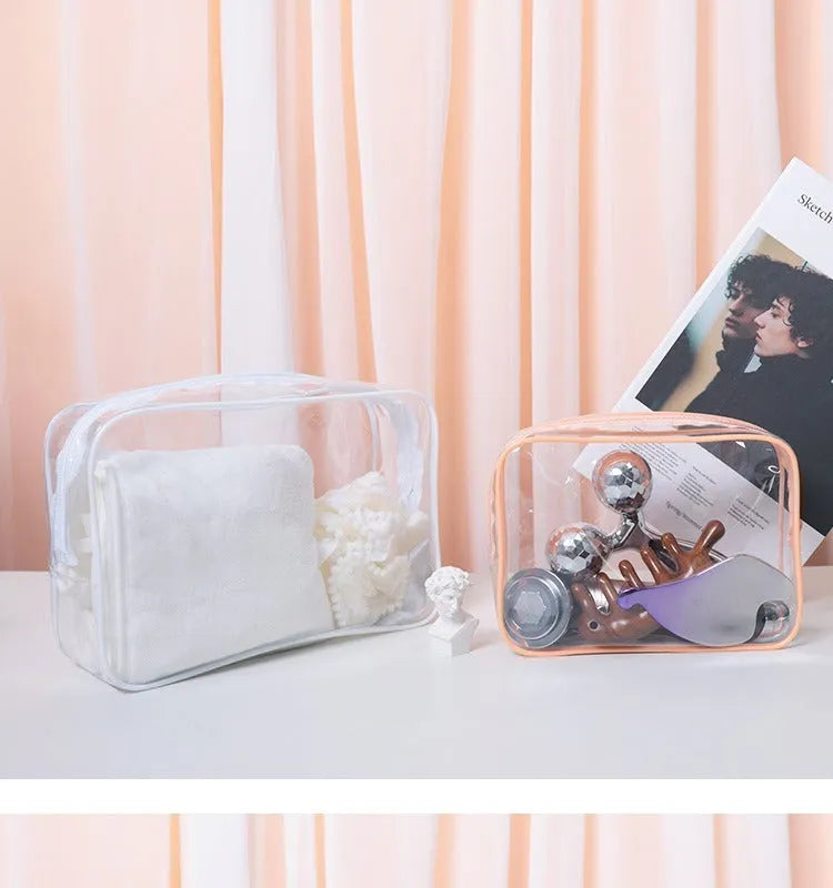 Three semi-transparent PVC makeup bags in black, pink and white colours showing cosmetic storage