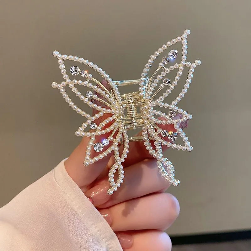 Butterfly-shaped alloy hair clip for women with rhinestone or pearl decoration.