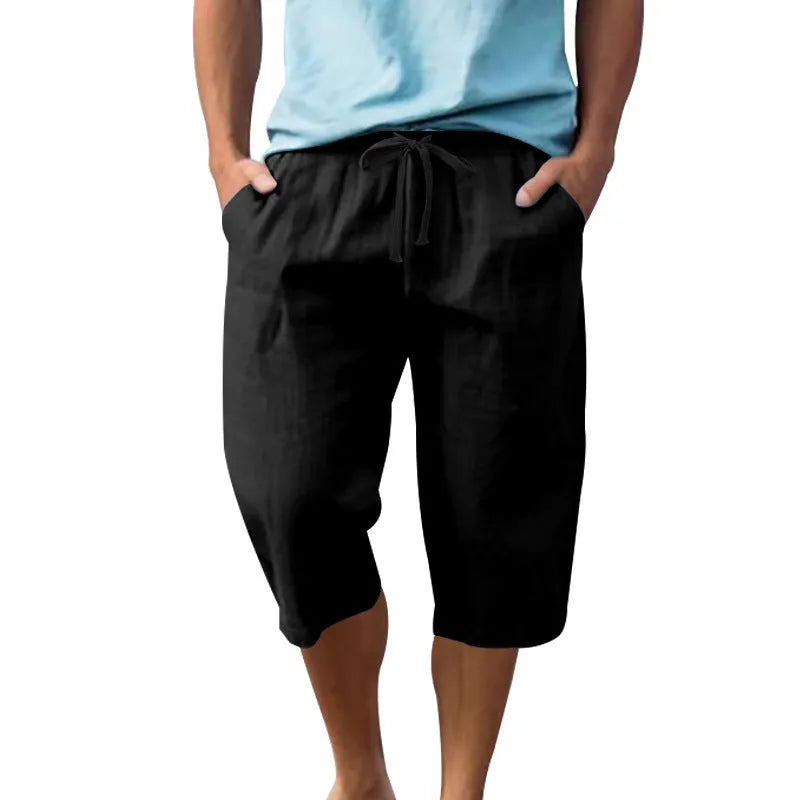 Man wearing light blue linen casual shorts with a cropped length and high waist.