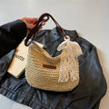 Women's woven straw messenger bag with hollowed design in khaki colour showing vertical square shape