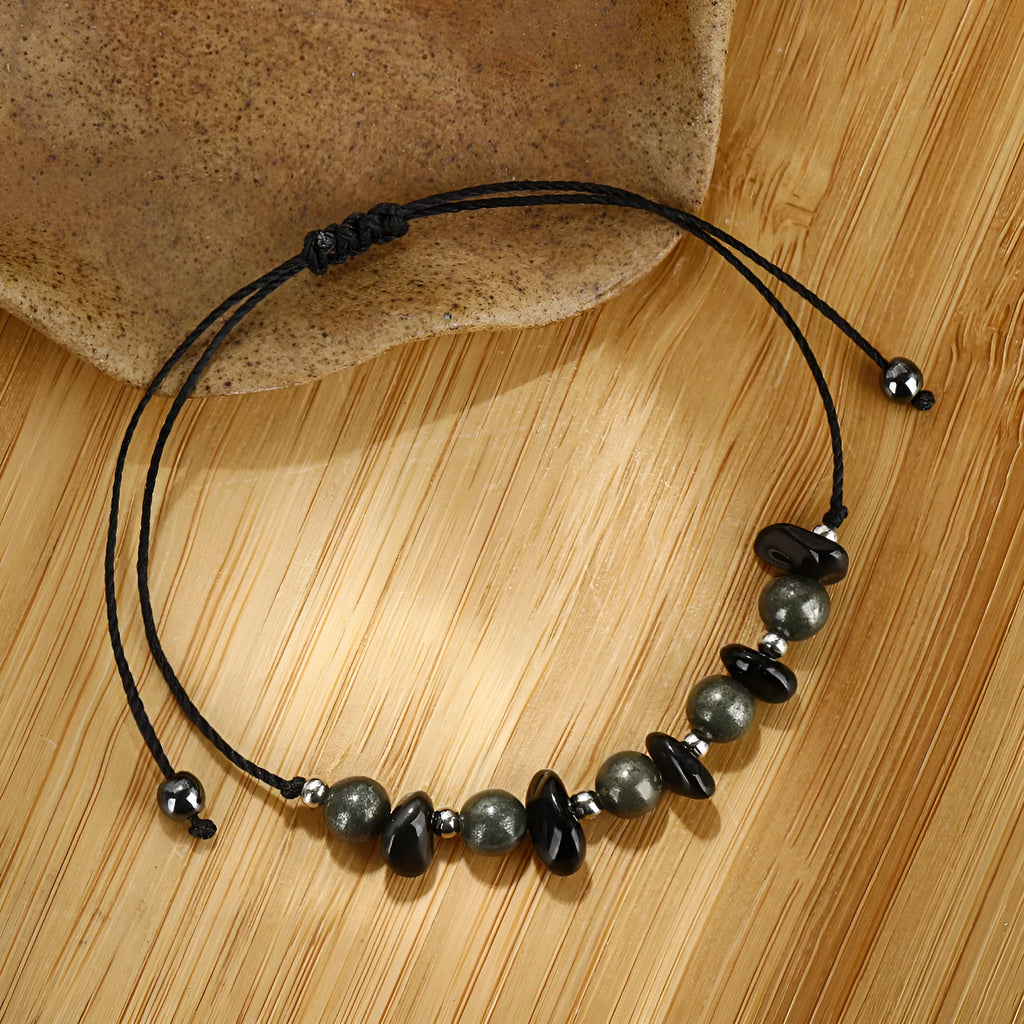 Black garnet stone bracelet with geometric beads and moon charm on wrist