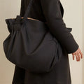 Women's large capacity Oxford cloth crossbody shoulder bag in black or light brown for travel and camping.