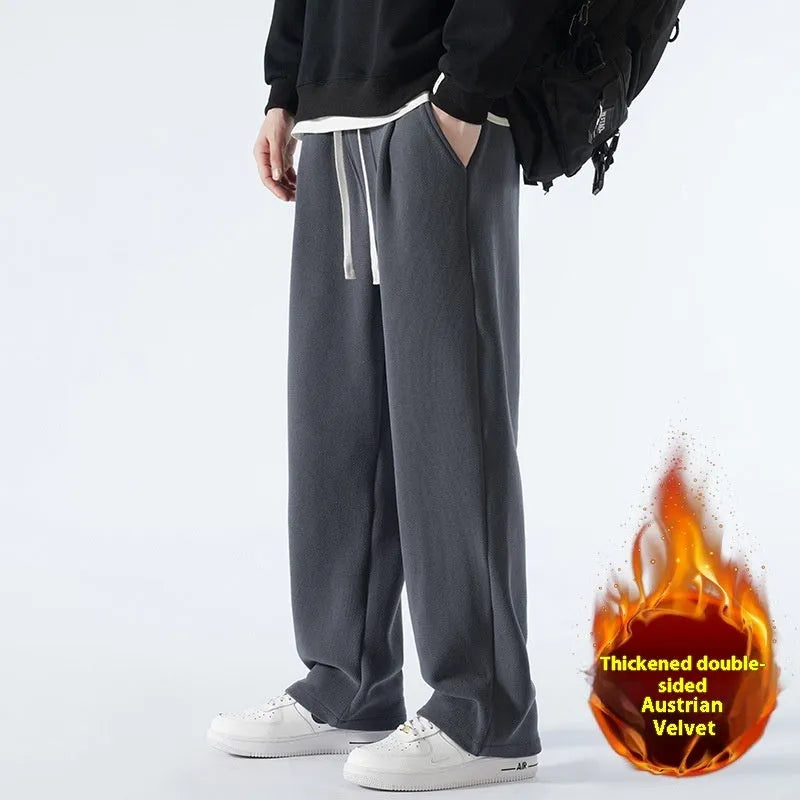 Men's apricot fleece-lined casual sports trousers with a loose fit and drawstring waist, laid flat.