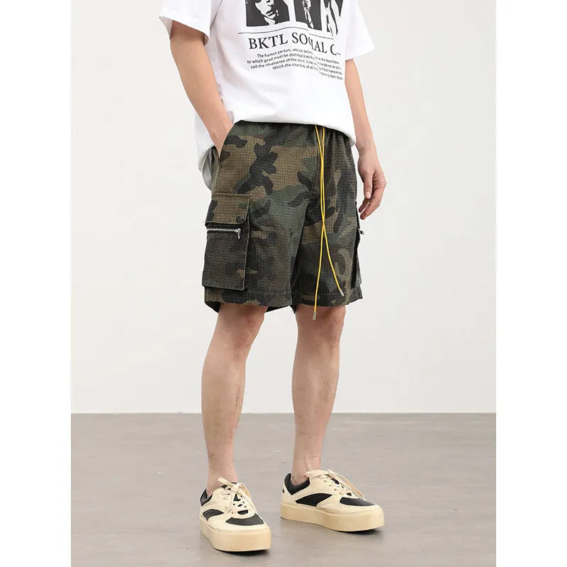 Men's camouflage pattern multi-pocket work shorts in a cropped length.