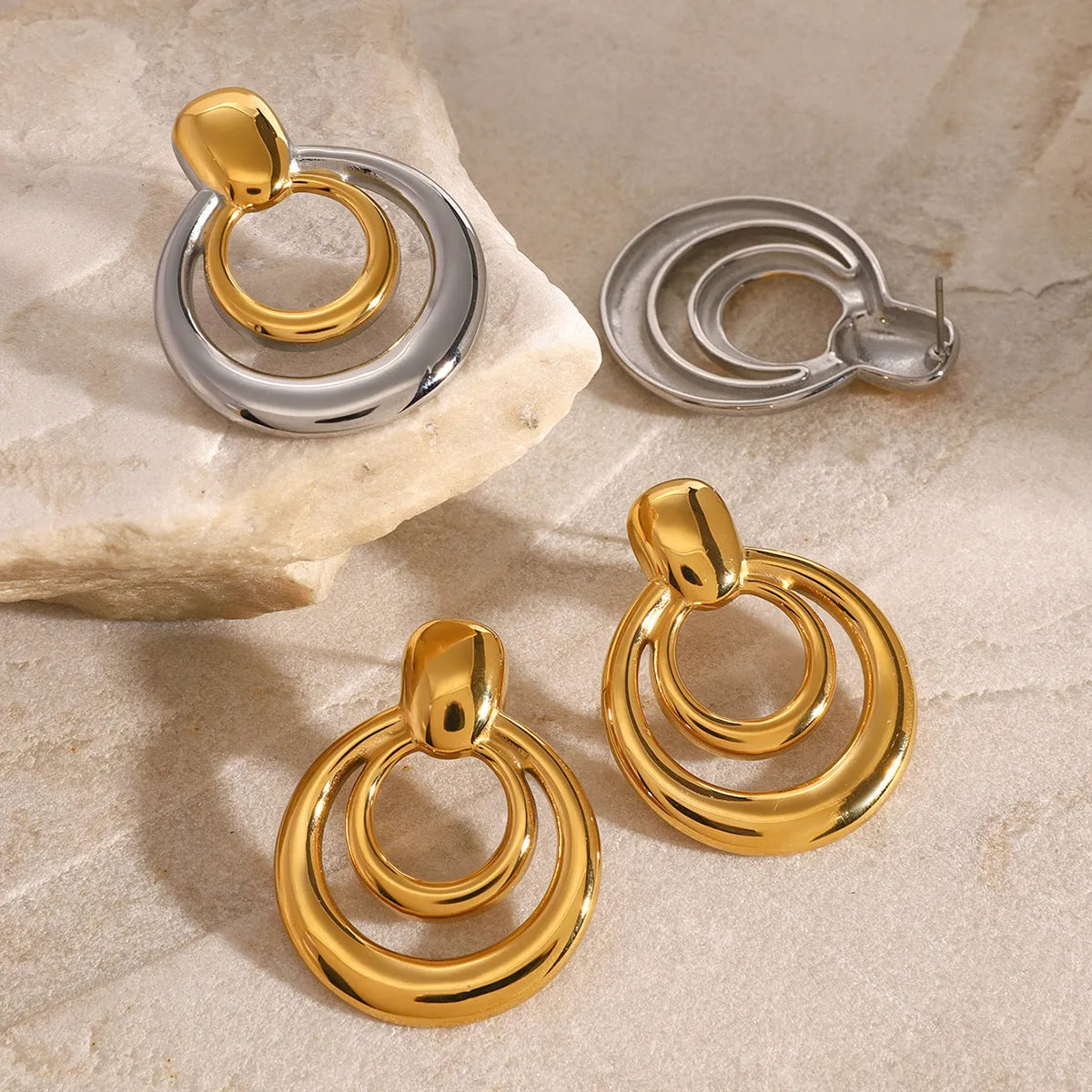 Golden titanium steel round stud earrings with double-layer hollow geometric design