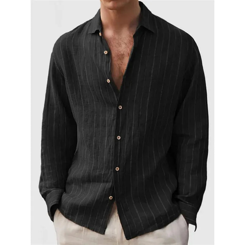 Man wearing a loose, long sleeve striped shirt in a cardigan style.