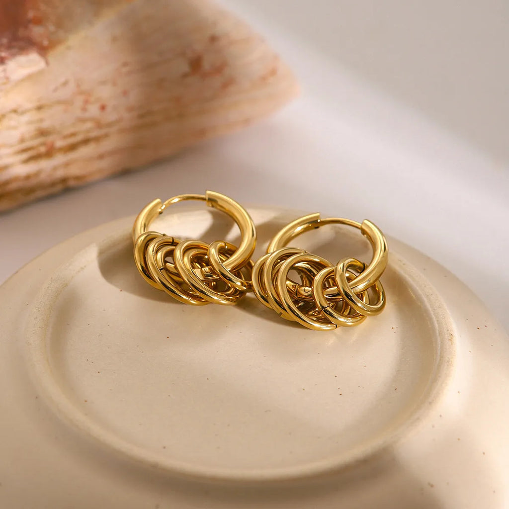 A pair of stainless steel ins style earrings with an electroplated silver or gold tone finish.