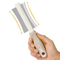 White 2 in 1 pet deshedding brush showing comb side and blade side with ergonomic handle