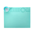 Light blue silicone painting mat measuring 50 by 40 cm on a wooden table