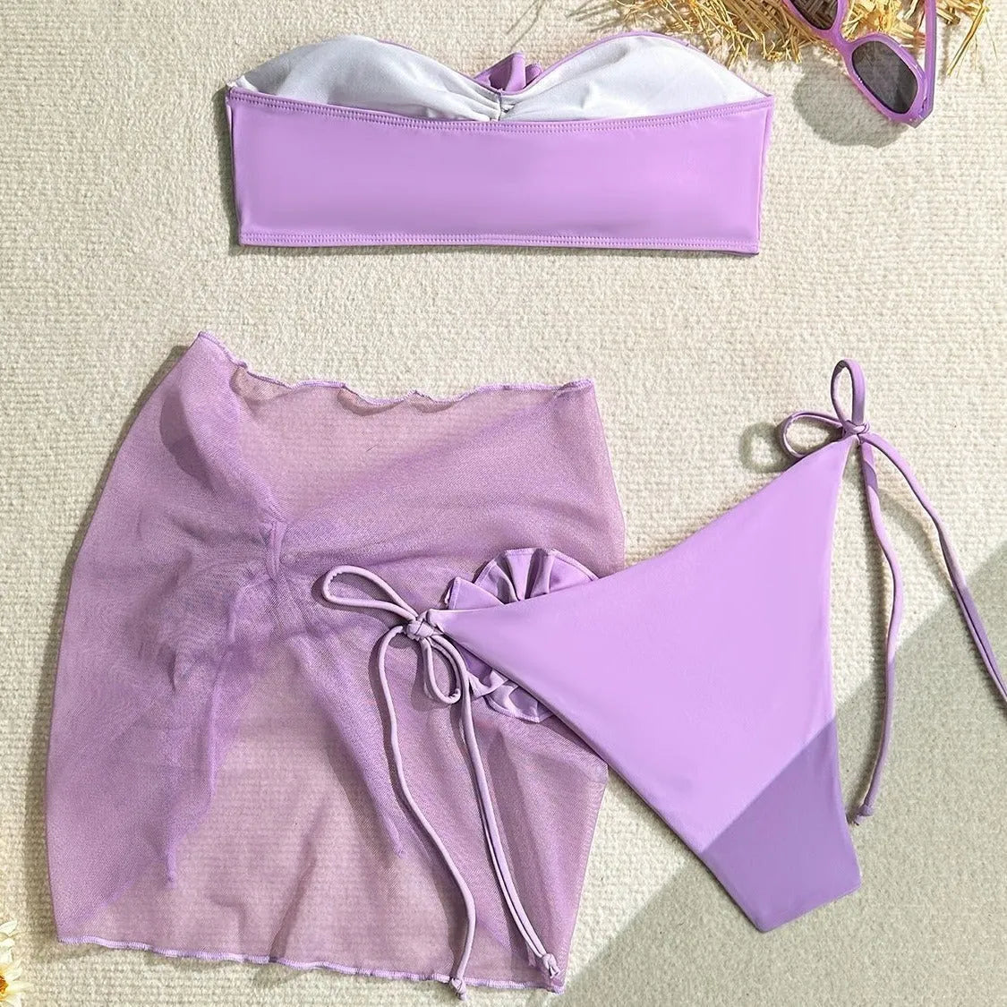 Women's pink tube top swimsuit with large 3D flower and matching skirt set on beach