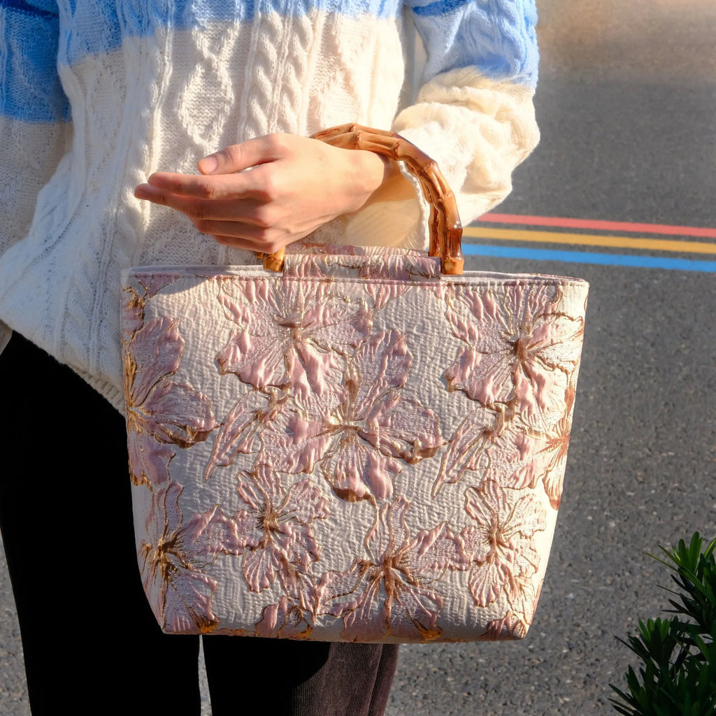 Light blue women's canvas bag with gold bronzing flower pattern showing double shoulder straps and square shape