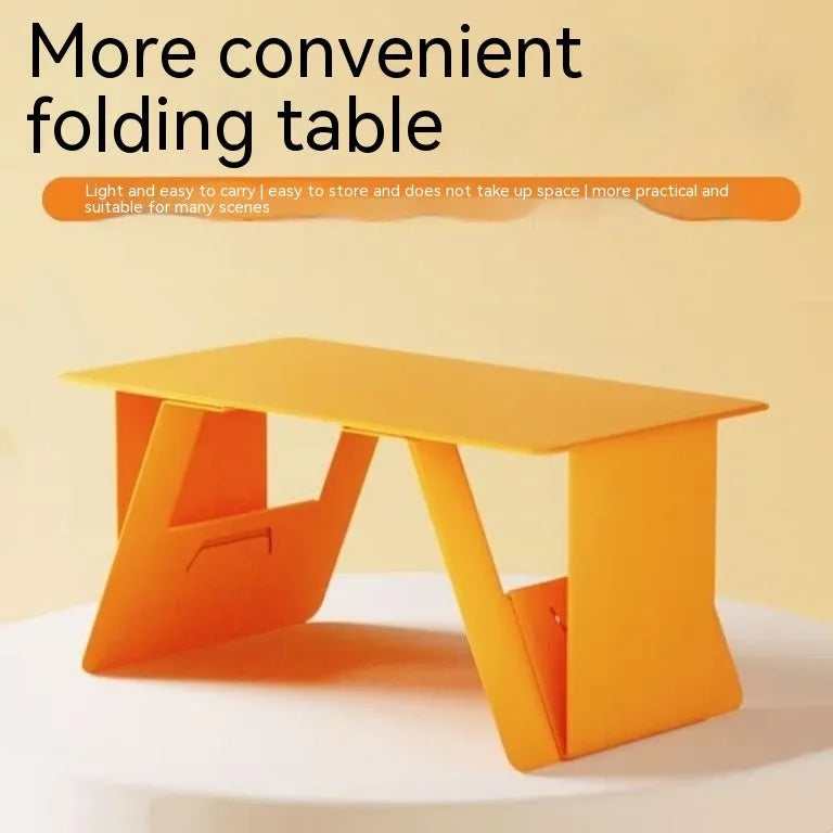 Foldable wooden laptop stand in black, raised on a desk with space underneath
