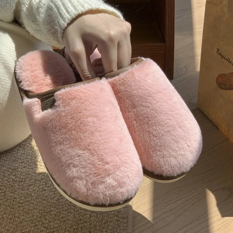 Winter plush slippers in blue with non-slip PVC sole and car stitching detail on the upper.