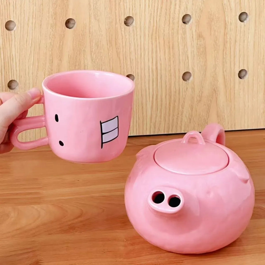 Creative ceramic piggy teapot nose mug set with pink pig pot and rabbit cup on a table