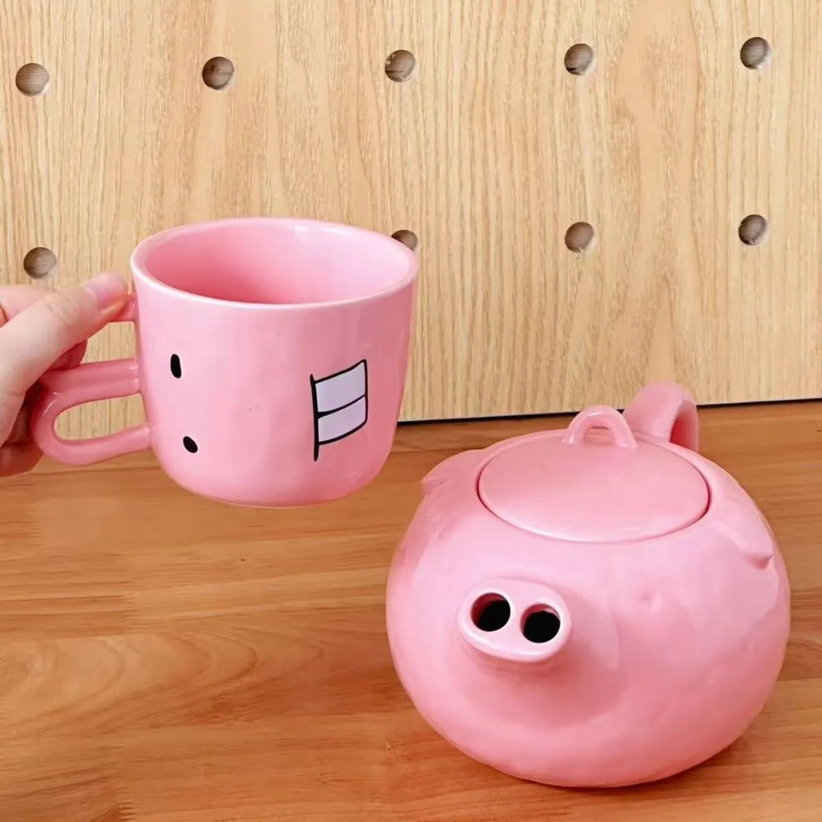 Creative ceramic piggy teapot nose mug set with pink pig pot and rabbit cup on a table
