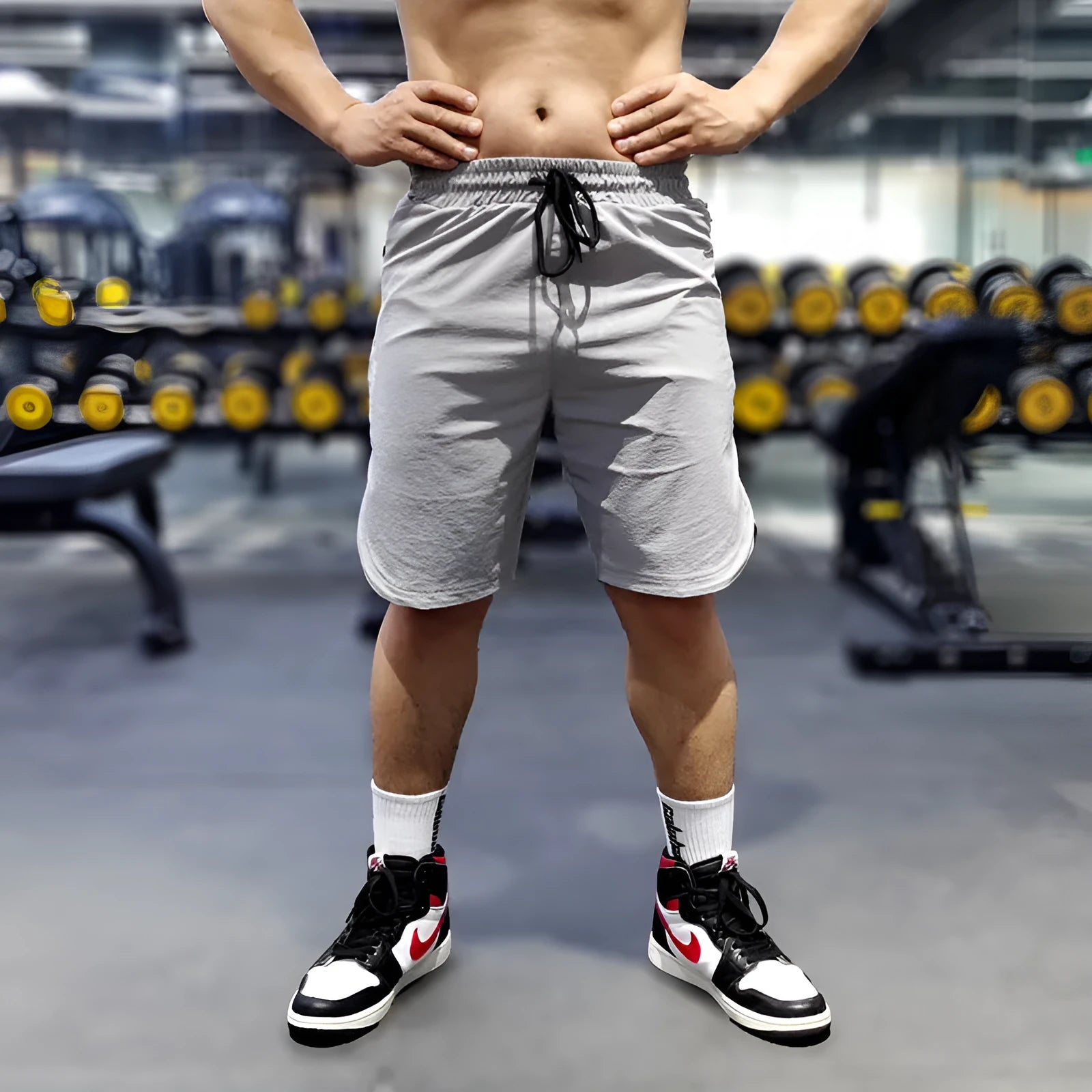 Man wearing thin black quick-dry running shorts made of nylon and spandex for sports.