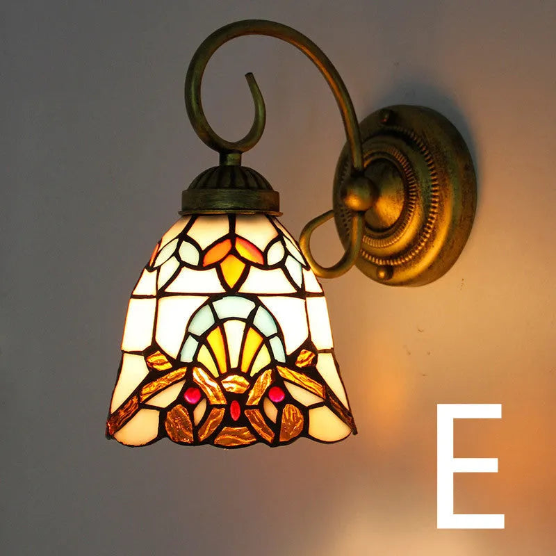 A coloured stained glass wall lamp in a simple contemporary style, mounted on a wall.