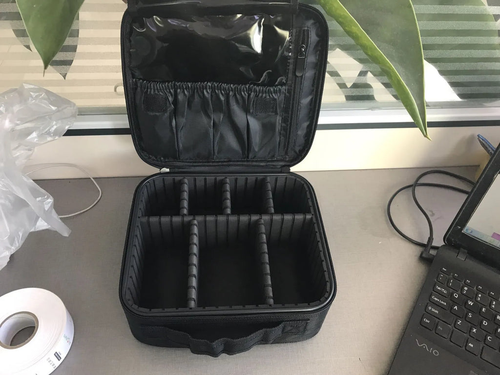 Mini black nylon cosmetic bag with zip closure, 26x22x12cm, shown open with make-up inside
