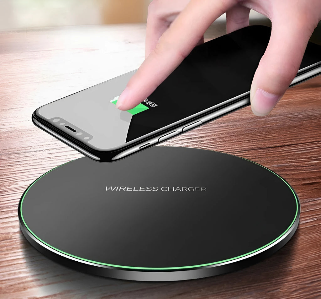 Black ultra-thin square wireless fast charger with USB cable on a desk