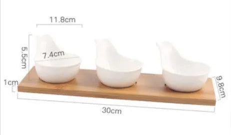 Porcelain ceramic dried fruit dish with compartments on wooden serving board