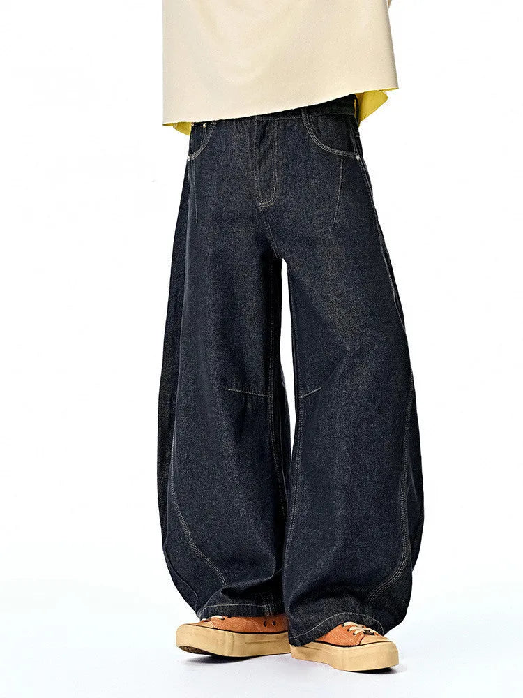 Men's wide leg denim trousers in original cow colour, laid flat to show mid-waist and relaxed fit.