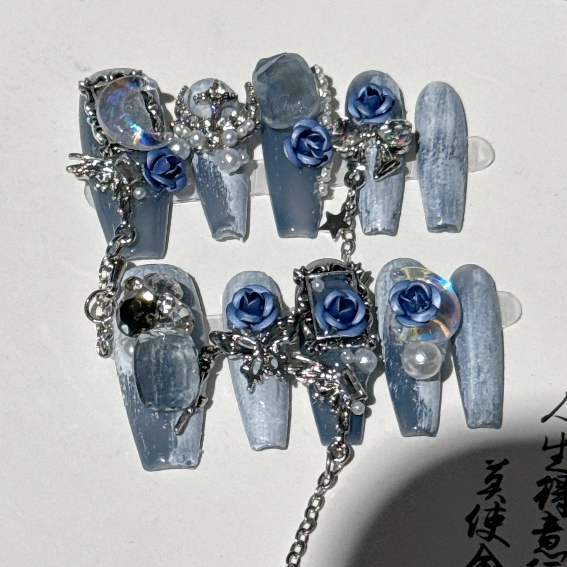 Evening manicure set with ornate rose pattern in heavy industry night blue colour