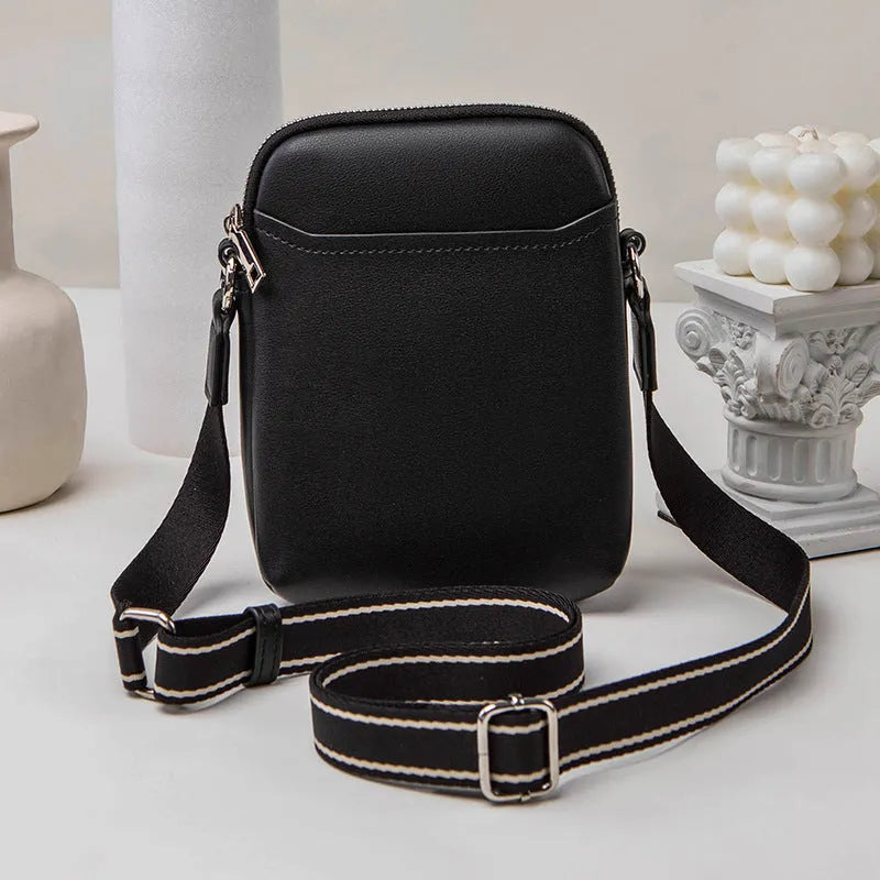 Solid colour crossbody phone bag for women in black, made from PU with an adjustable strap.