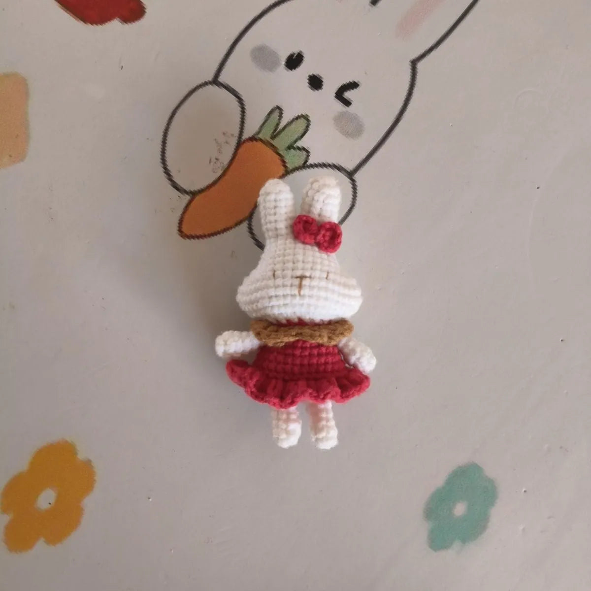 Hand-crocheted wool rabbit keychain pendant on a metal ring.