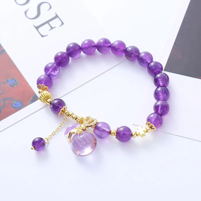 Purple amethyst crystal bracelet with geometric beads showing money bag charm and peace buckle pendant options