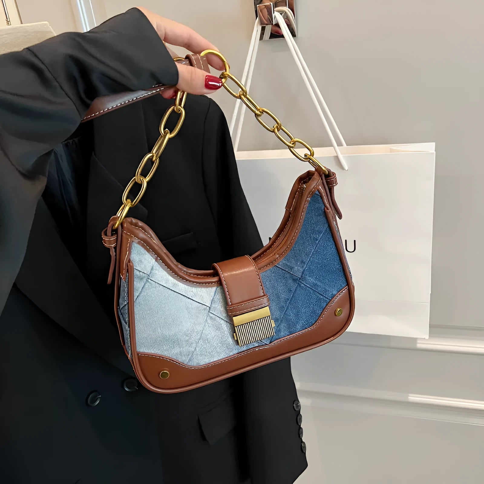 Brown soft denim women's shoulder bag with diamond mesh and chain details, showing bucket shape.