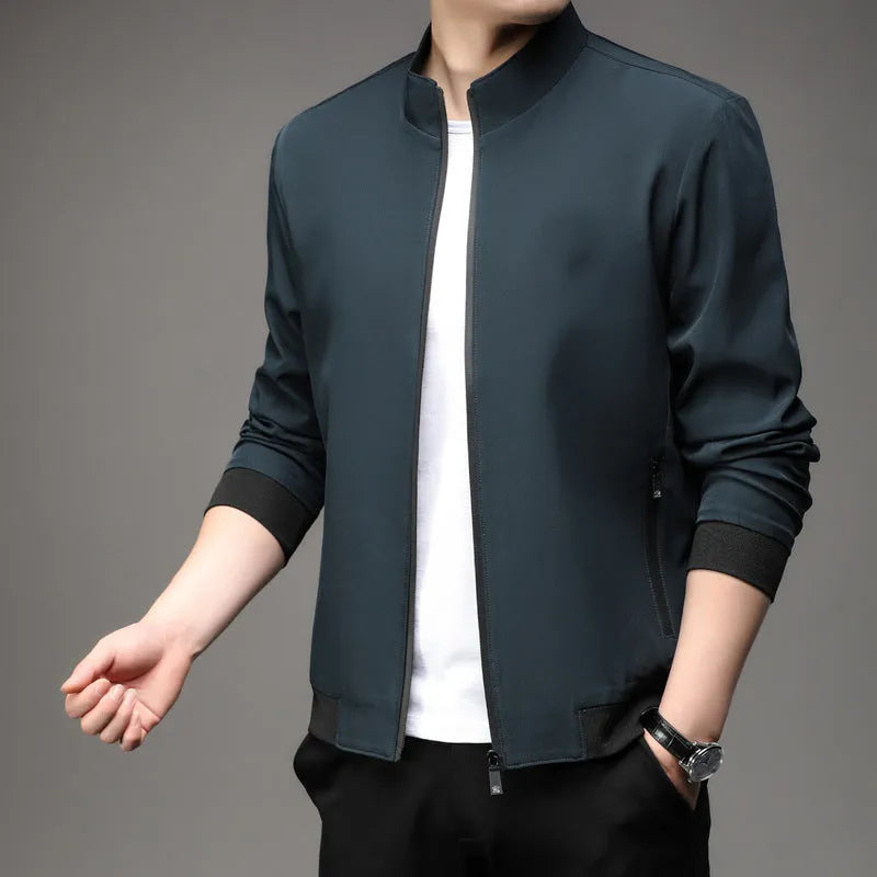Man wearing a loose-fit grey Korean-style lapel jacket with zipper pockets.