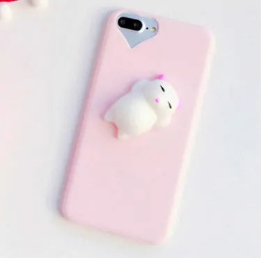Soft silicone iPhone case with a raised 3D cartoon cat design on the back, shown in pink.