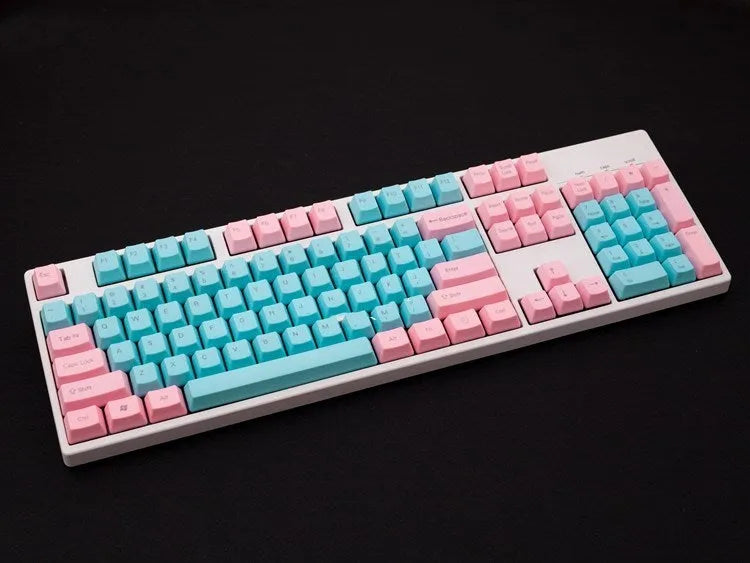 Pink PBT mechanical keyboard keycaps with side-engraved legends showing 1.5mm thickness