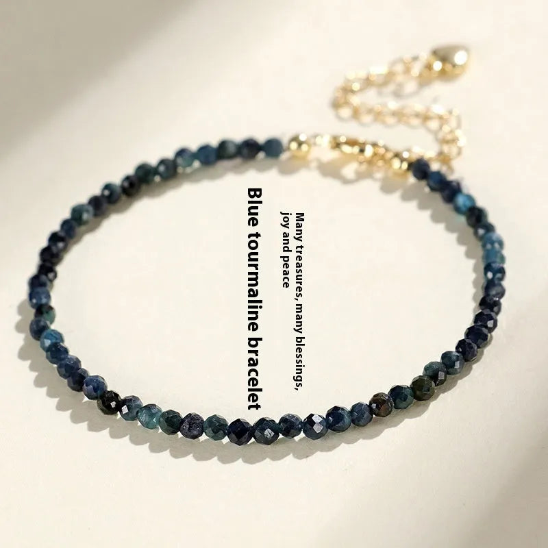 Women's blue tourmaline bracelet with 3mm beads and spacer bead design.