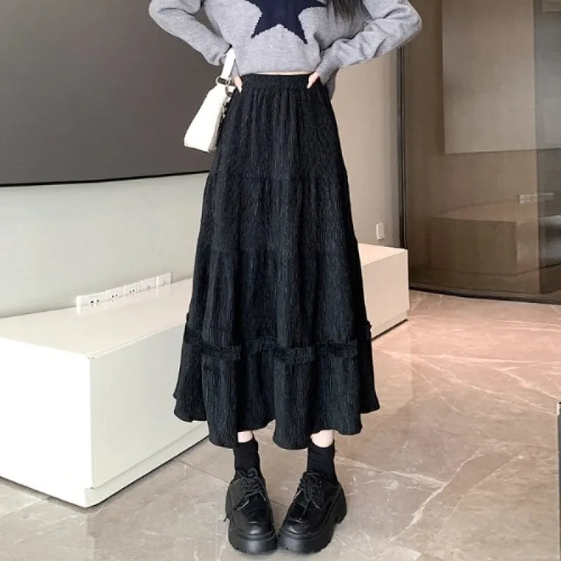 Corduroy midi A-line skirt with elastic waistband in milk white, shown on a model.