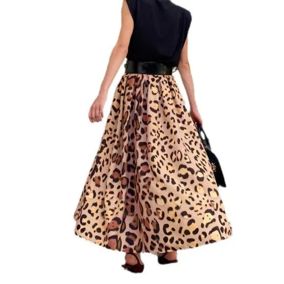 Brown leopard print women's long A-line skirt with a defined waist and wide, flowing hem on a neutral background.