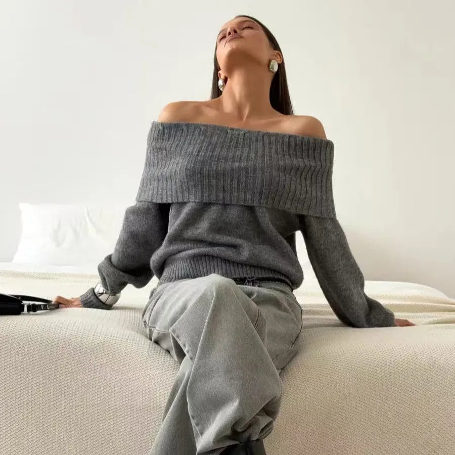 Grey off-the-shoulder women's sweater with a 3D knit pattern and strapless neckline on a hanger.